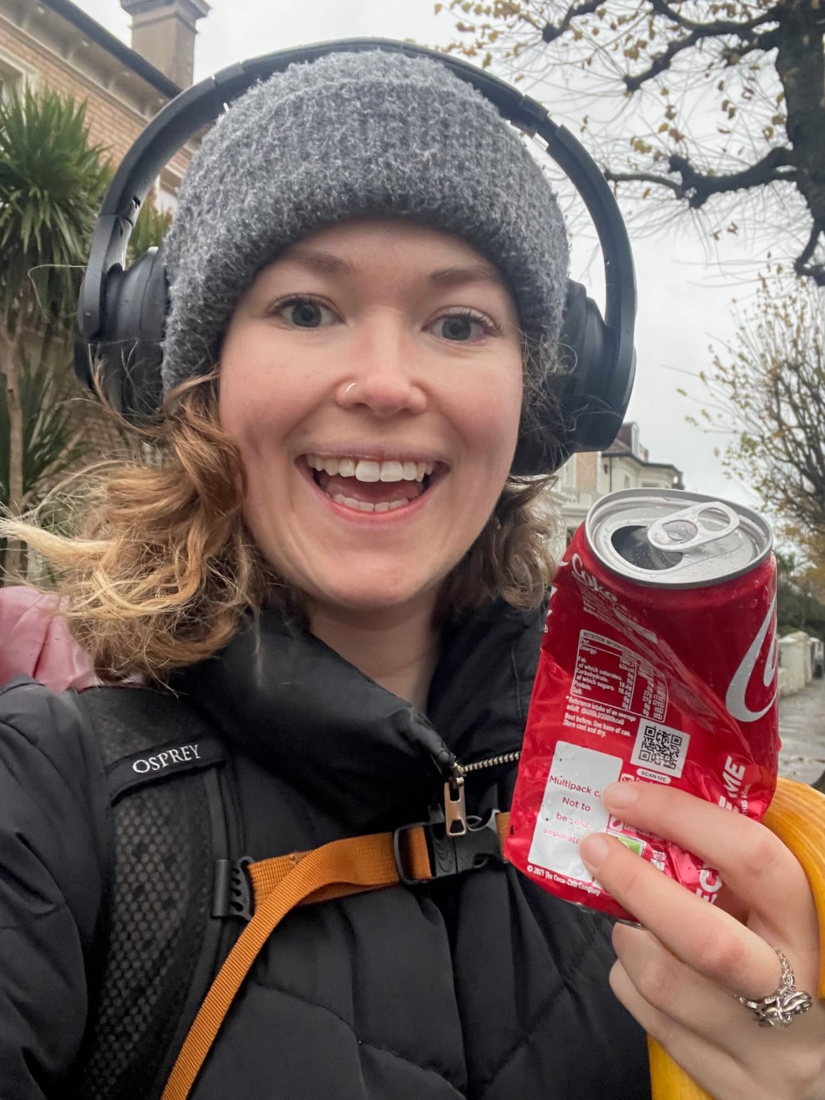 Woman taking a selfie with an old coke can